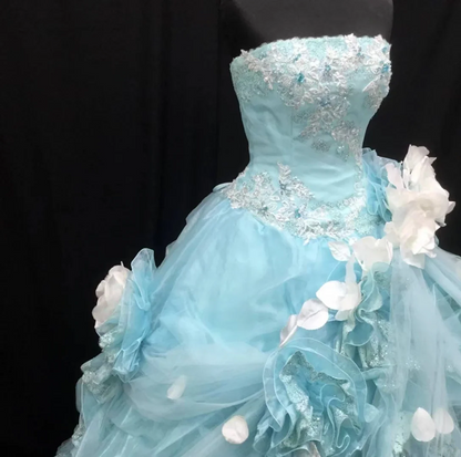 Light blue strapless ball gown with a cinched waist and a voluminous puffy skirt; bridal gown R7301