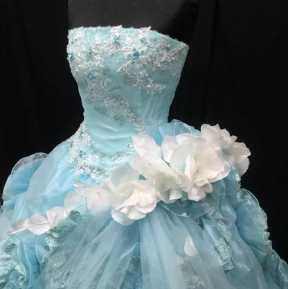 Light blue strapless ball gown with a cinched waist and a voluminous puffy skirt; bridal gown R7301