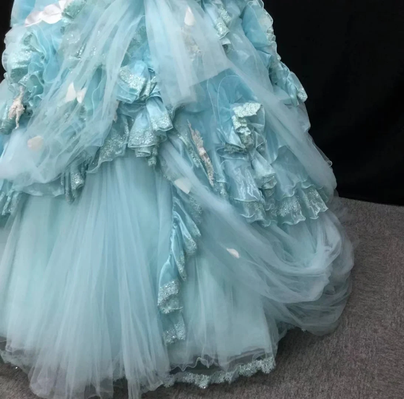 Light blue strapless ball gown with a cinched waist and a voluminous puffy skirt; bridal gown R7301