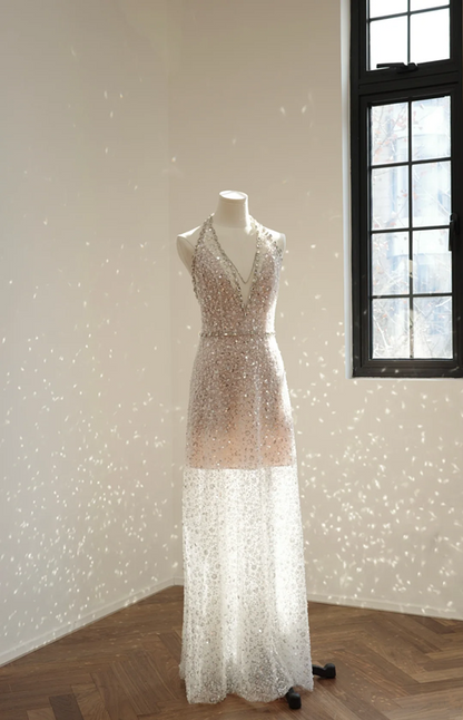 A sexy ball gown with a silver rhinestone halter neck and fitted waist, featuring a foundation and a bridal gown. R8550