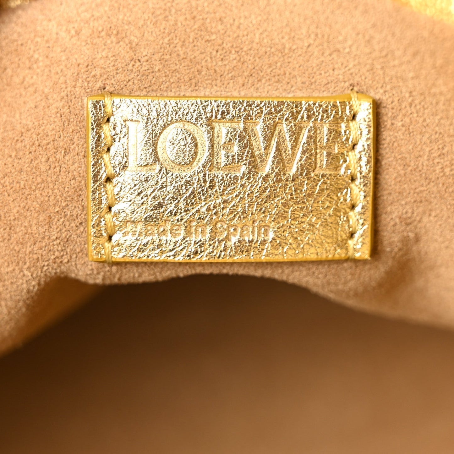 Metallic Laminated Lambskin Medium Scale Flamenco Knot Clutch Gold